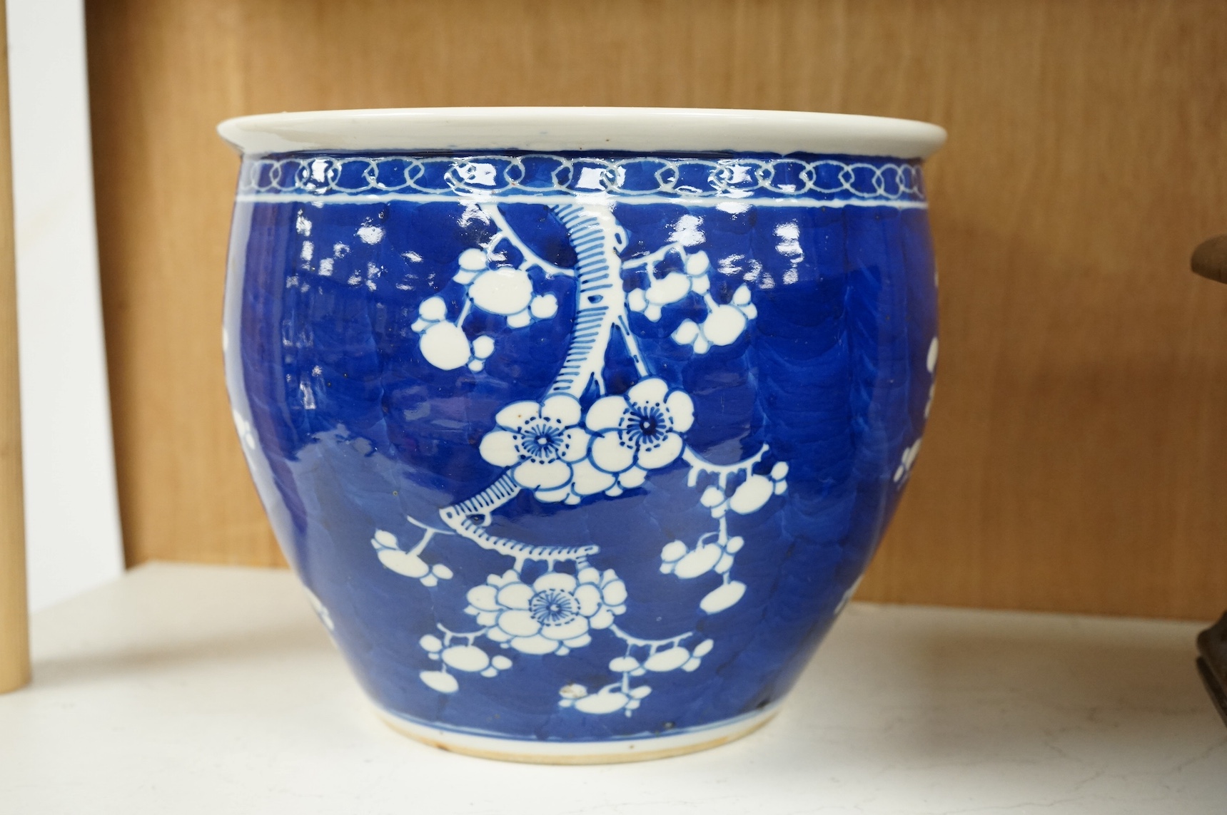 A Chinese blue and white ‘prunus’ jardiniere, 20cm tall. Condition- chipped